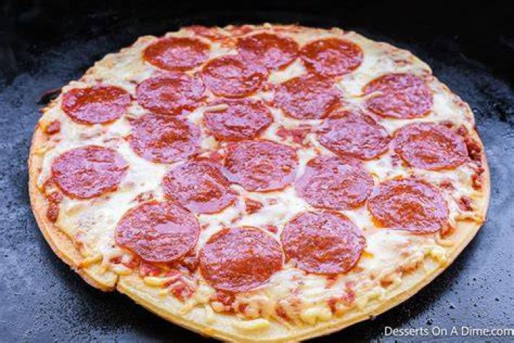 Can I cook a frozen pizza on the grill?