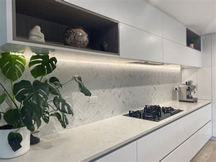 Can you put kitchen splashback over tiles?