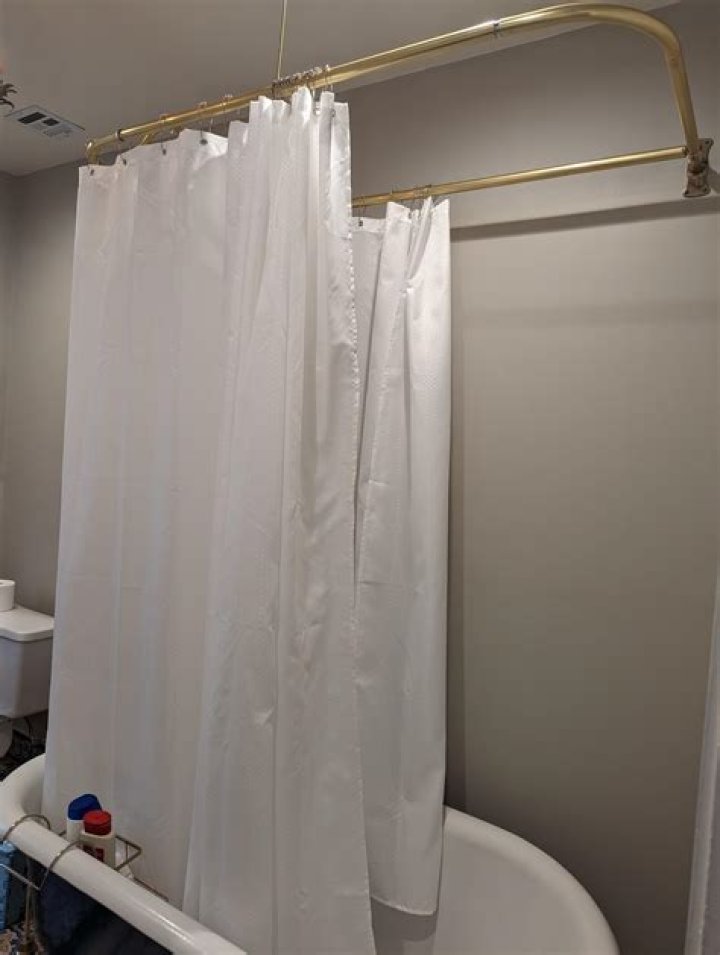 How do I keep my shower curtain in the bathtub?
