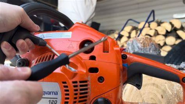 How do you adjust a carburetor on a Husqvarna 235?