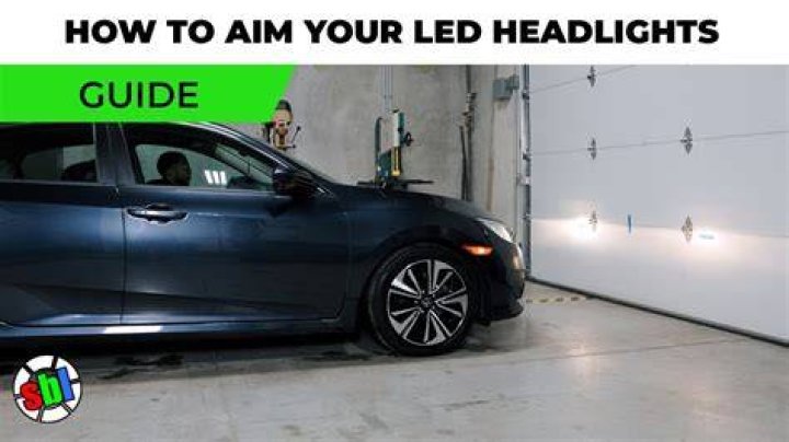 How do you adjust the headlights on a Ford Taurus?
