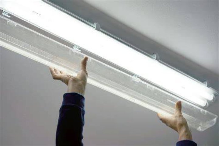 How do you change a fluorescent light lens?