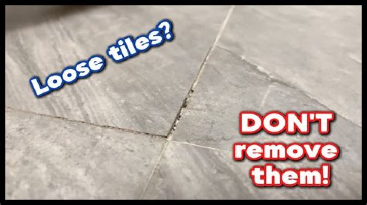 How do you fix a loose floor tile?