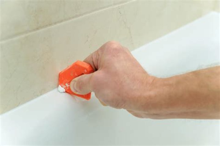 How do you redo bathtub caulking?