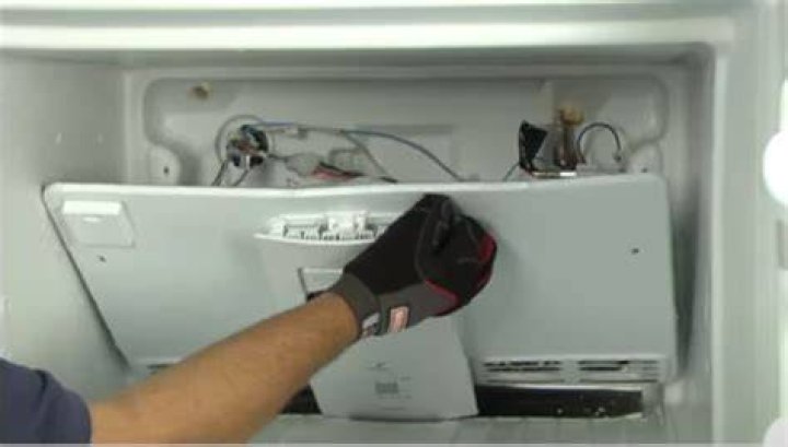 How do you remove the defrost button on a Whirlpool refrigerator?
