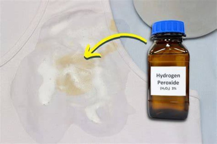 How does hydrogen peroxide remove stains from clothes?