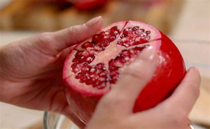 What is the correct way to open a pomegranate?