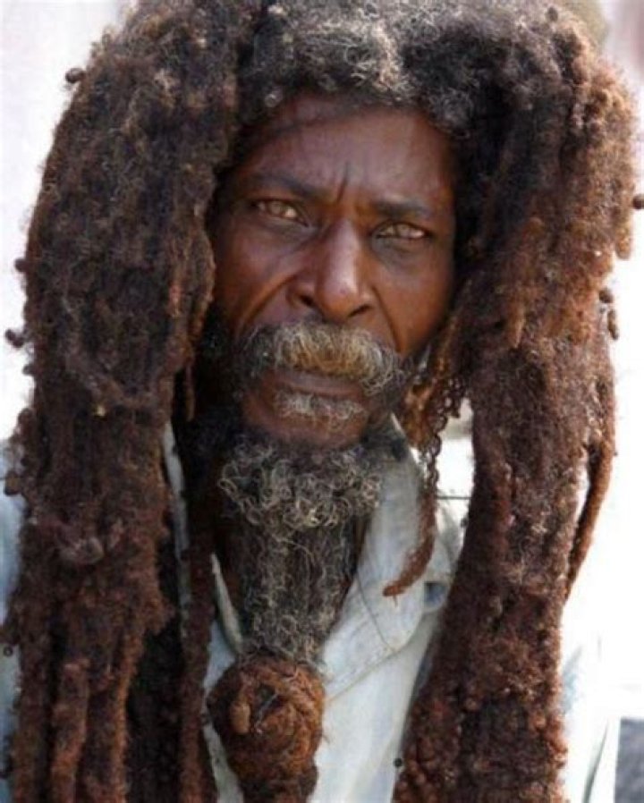 Why do Rastafarians cover their dreadlocks?